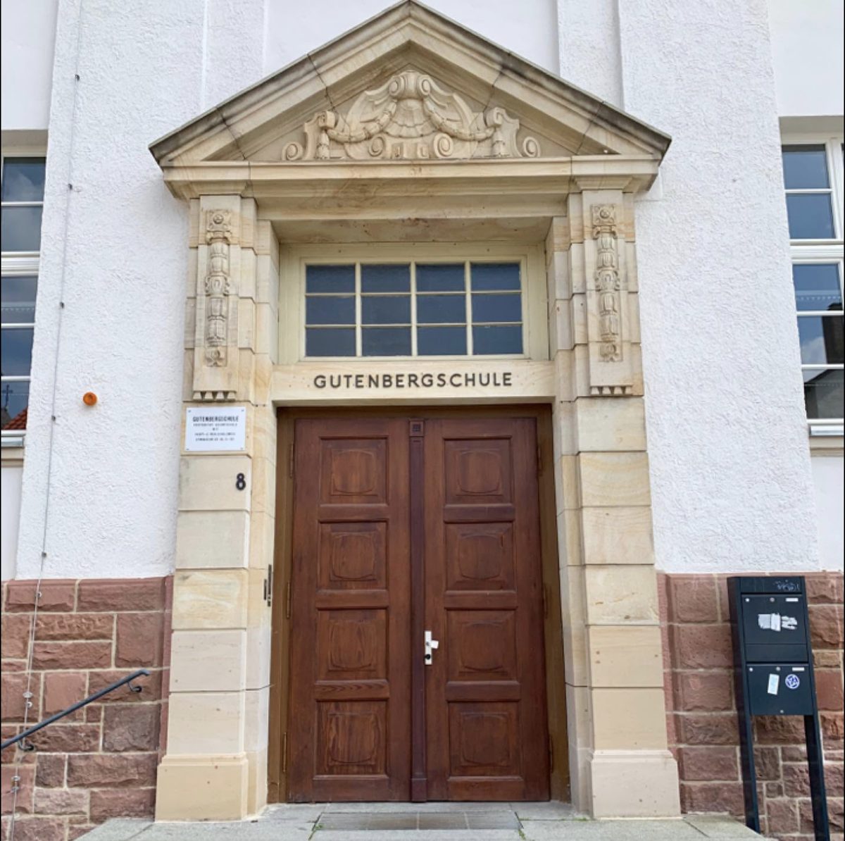 Das Hauptportal der Gutenbergschule mit dem Sandsteinrahmen und dem Schriftzug „Gutenbergschule“ über der Tür